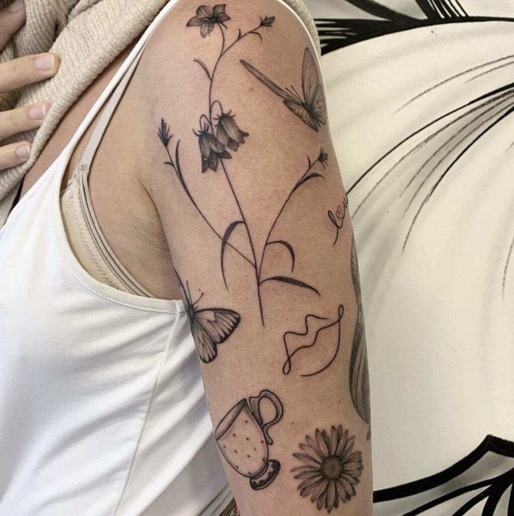 many tattoos on woman arm