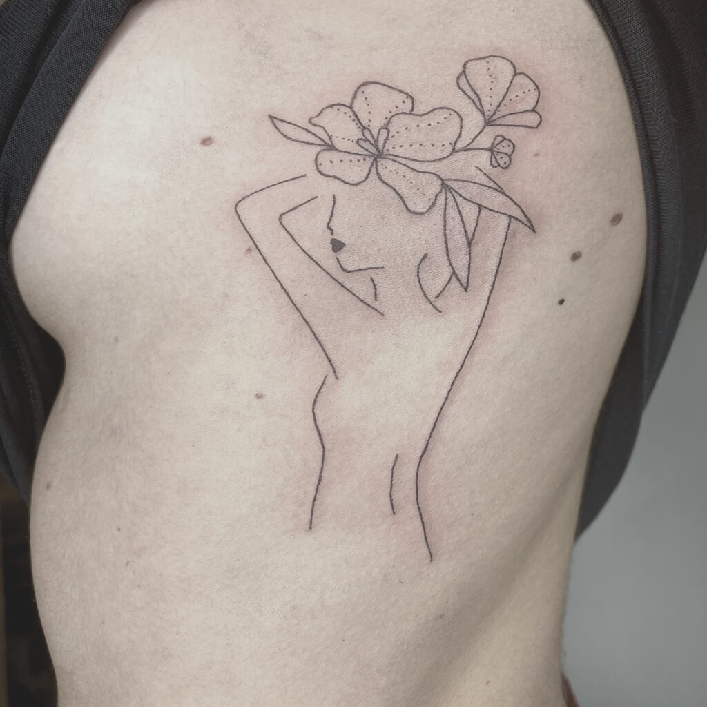 woman with flower in head tattoo